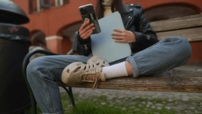 A chic young lady in a leather jacket and pink hat is talking on the phone with a tablet in her hands. - Powered by Shutterstock - Get 15% off with code: PIKWIZARD15