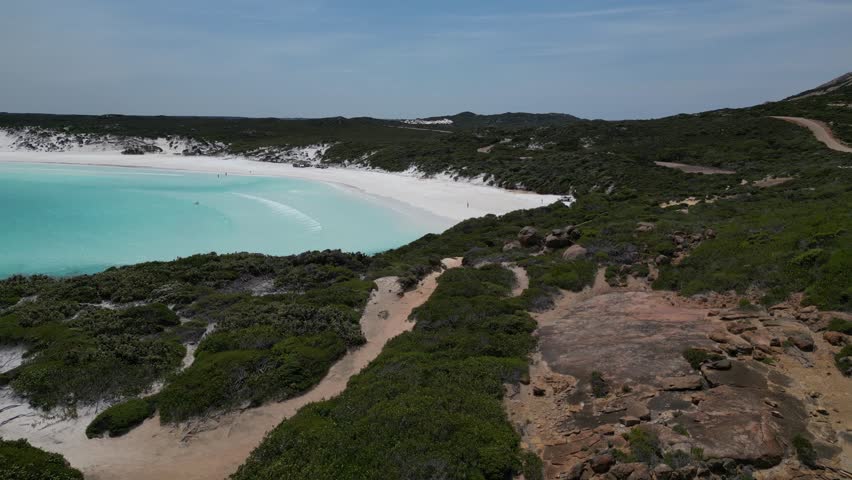 The turquoise water and white foamy waves of Wharton Beach in Western Australia.