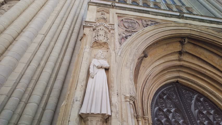 Looking at the stone sculptures figure, entrance to Norwich cathedral
