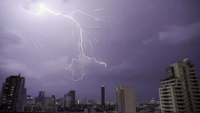 Lightning and rain in modern city center of Bangkok. Storm clouds with lightning strike bolts passing over night city of Bangkok cityscape. - Powered by Shutterstock - Get 15% off with code: PIKWIZARD15