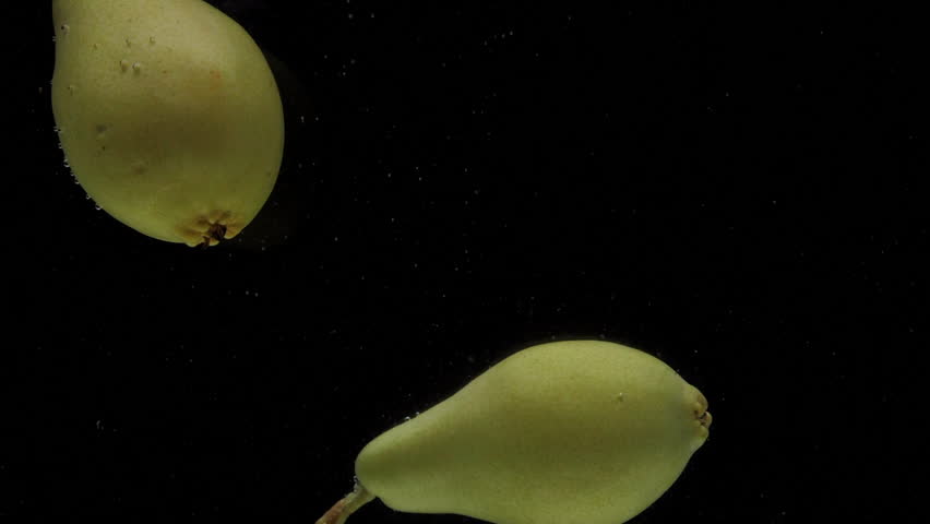 Slow motion two pear falling into transparent water on black background. Fresh fruits splashing in aquarium. Organic fruit, healthy food, diet, fructose, air bubbles - Powered by Shutterstock - Get 15% off with code: PIKWIZARD15