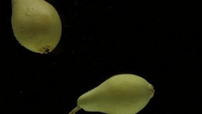 Slow motion two pear falling into transparent water on black background. Fresh fruits splashing in aquarium. Organic fruit, healthy food, diet, fructose, air bubbles - Powered by Shutterstock - Get 15% off with code: PIKWIZARD15