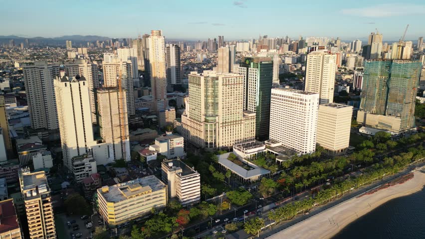 Makati, Metro Manila, Philippines - May 2024. Shot of Manila Baywalk Dolomite Beach and skyline.