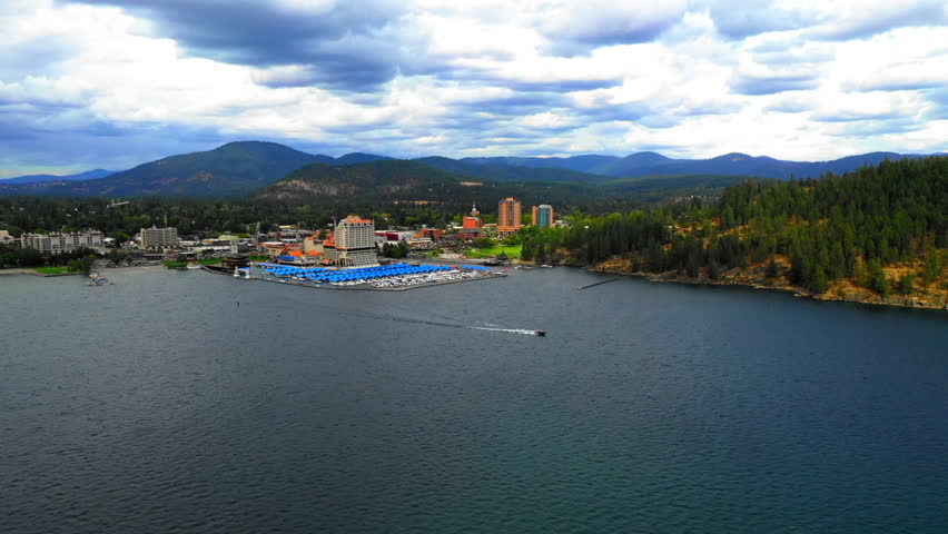 Aerial Panning Beautiful Shot Of Harbor By Hotel In Town, Drone Flying Over Rippled River - Coeur d