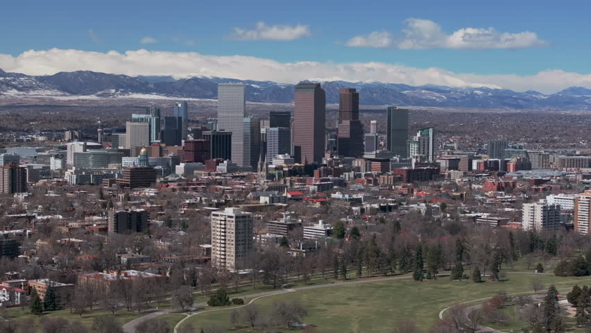Downtown Denver Colorado City Park Flat Irons Boulder Aerial drone USA Front Range Mountain foothills landscape skyscrapers Wash Park Ferril Lake daytime sunny clouds neighborhood right motion