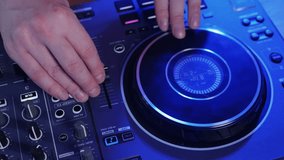 DJ playing music scratch on festival in night club. Techno musician with headphones and sunglasses performing at nightclub for concert crowd of people, city bar. - Powered by Shutterstock - Get 15% off with code: PIKWIZARD15