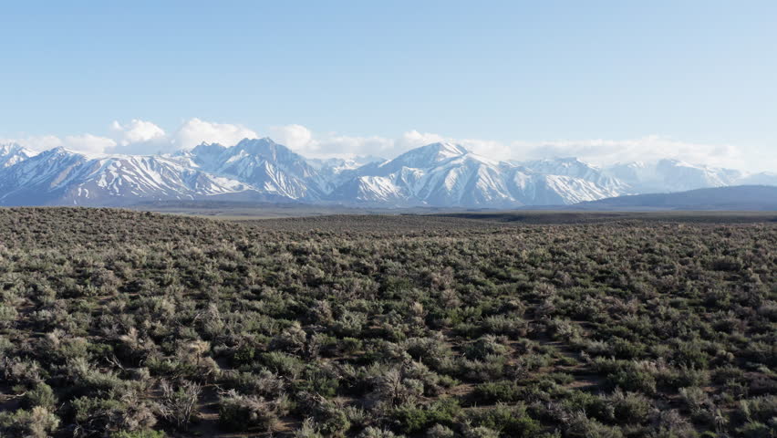 Drone flies forward and revealing Eastern Sierra Nevada Mountains in California landscape view. 