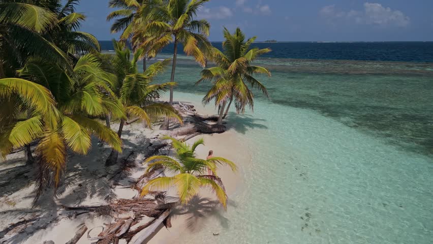 Girl waking on a beach in a remote island in Kuna Yala, Panama.