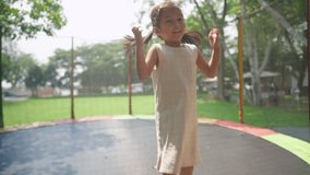 Active happy asian kid playing inside summer park during the day, jumps and laughs out loud while having fun on outdoor recreational trampoline. Lifestyle leisure and activity for child development - Powered by Shutterstock - Get 15% off with code: PIKWIZARD15