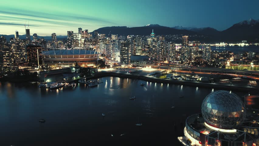 Aerial hyperlapse of night cityline with skyscrapers. Vancouver, Canada.