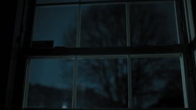 Silhouette of a tree on the dark background of lightning. Heavy rain storm rain falls. view from houses. Storm night footage.  - Powered by Shutterstock - Get 15% off with code: PIKWIZARD15