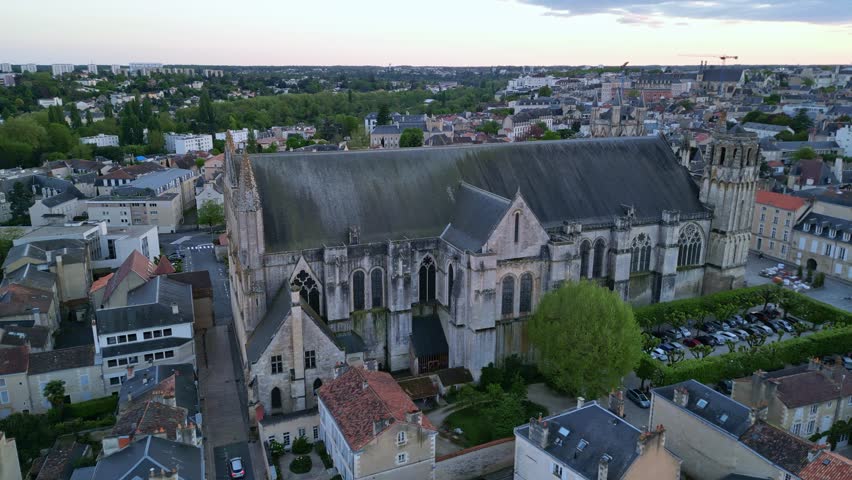 Cathedral of Saint Peter or Pierre at sunset in Poitiers city, France. Aerial drone sideways