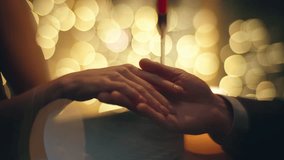 Evening couple touching hands at blurred background closeup. Gorgeous happy woman talking to boyfriend enjoying night date atmosphere. Young beautiful lady in dress flirting unknown man at restaurant - Powered by Shutterstock - Get 15% off with code: PIKWIZARD15