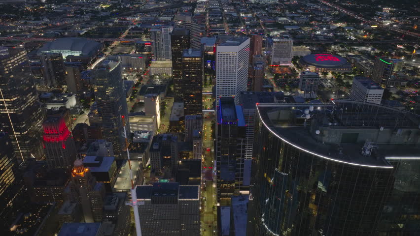 Breathtaking view of downtown Houston at night, capturing the vibrant city lights, illuminated skyscrapers, and bustling streets from above, showcasing the urban beauty of the city