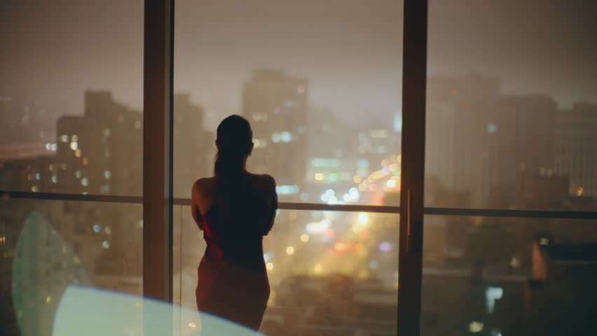 Silhouettes romantic couple embracing at evening window cityscape back view. Love pair hugging at dating against at night city background. Young people bonding at dark hotel. Relationships concept