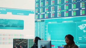 Administrative assistant examining important big data visualizations on a huge display, creating an analysis to review key performance indicators and business efficiency. Camera A. - Powered by Shutterstock - Get 15% off with code: PIKWIZARD15