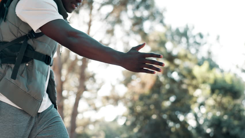 Hiking, friends and helping hand in forest for support, climbing and assistance on vacation outdoor. Adventure, journey and holiday in nature for wellness, man and female person in countryside