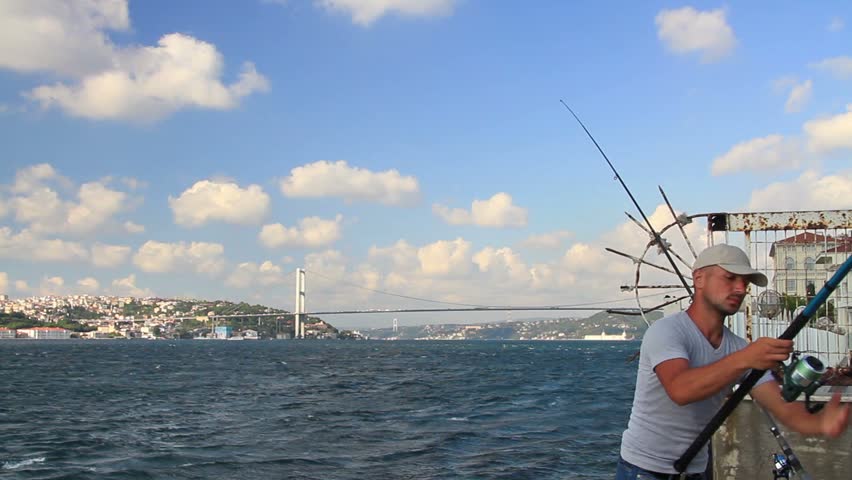 ISTANBUL - AUG 26: Young fisherman along Bosporus Strait on August 26, 2011 in