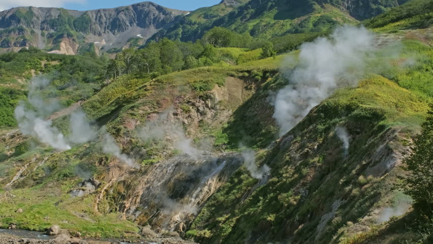 Hot springs and fumaroles in famous Valley of Geysers, Kamchatka peninsula, Russia, 4k