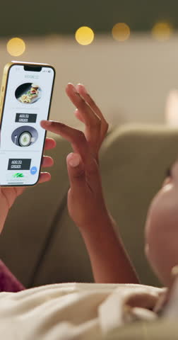 Hands, phone screen and food delivery app on sofa with scroll, thinking and choice for dinner in home. Person, smartphone and search for discount, sale and online shopping on mobil in apartment