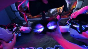 Point of view shot of a team of friends putting on virtual reality headset. Neon lights - Powered by Shutterstock - Get 15% off with code: PIKWIZARD15