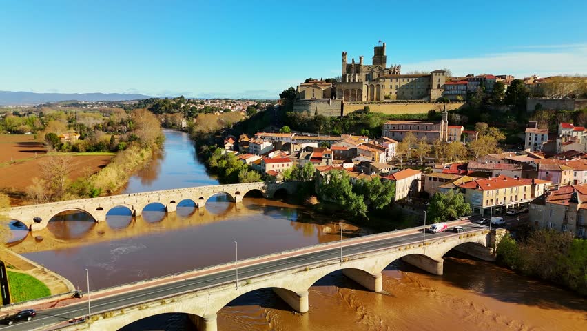 Aerial view of Beziers old town in France. The old bridge over the Orb river with the Cathedral of Saint Nazaire in Beziers, Southern France. 