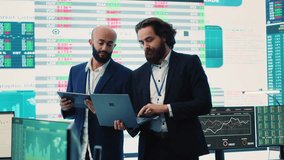 Team of investors analyzing profit amount and making decisions to fund another business project, examine big data on a huge display. Associates verifying efficiency and budget. Camera A. - Powered by Shutterstock - Get 15% off with code: PIKWIZARD15