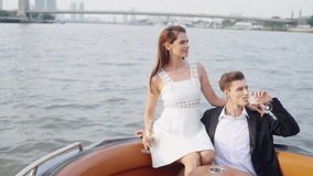 Caucasian couple enjoy urban outdoor lifestyle travel in the city celebrating special occasion drinking champagne together on private yacht sailing in the river at sunset on summer holiday vacation. - Powered by Shutterstock - Get 15% off with code: PIKWIZARD15