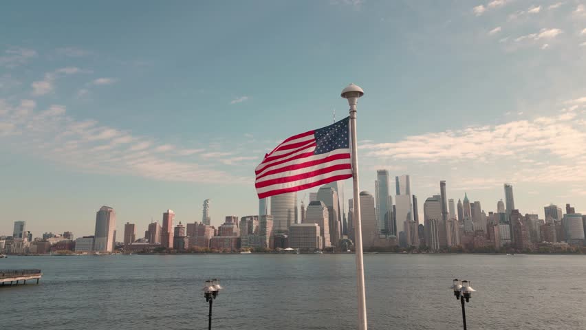 Manhattan, NYC aerial view. American flag in NYC. Memorial Day, Veteran's Day, 4th of July in NYC. American Flag Waving near New York City, Manhattan view. NYC, Manhattan skyline.