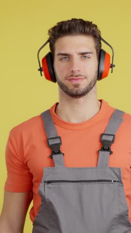 Serious worker standing with arms crossed looking at camera