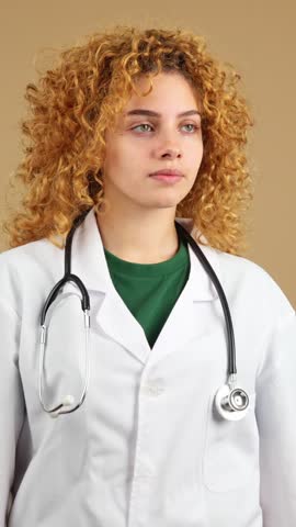 Serious female doctor lookin to copy space