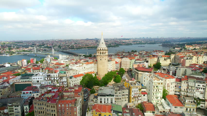 Aerial drone view of Istanbul, Turkey. Multiple residential buildings around the Galata tower, Golden Horn waterway on the background