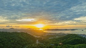aerial hyper lapse scenery sun shines through the sky over Chalong gulf.
4K video of Majestic sunrise landscape Amazing light of nature cloudscape sky above the ocean.
colorful sky sunrise background.