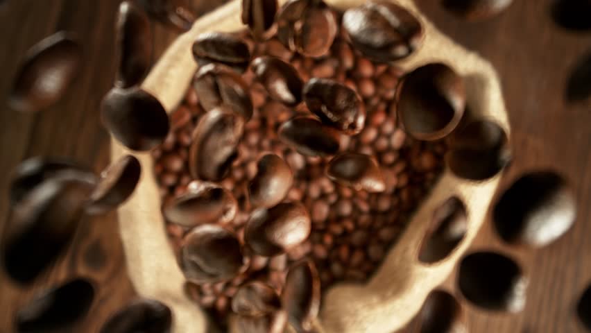 Super Slow Motion Shot of Falling and Rotating Coffee Beans Followed by Camera Motion at 1000fps.