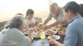 4K Happy Asian Multi-Generation family enjoy and fun spending time together having lunch eating seafood at beach restaurant during travel nature ocean at tropical island on summer holiday vacation.  - Powered by Shutterstock - Get 15% off with code: PIKWIZARD15