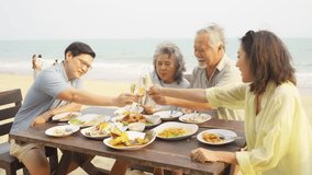 4K Happy Asian adult couple and aging parents enjoy outdoor lifestyle celebration dinner party drinking champagne together at tropical beach restaurant during travel ocean on summer holiday vacation.  - Powered by Shutterstock - Get 15% off with code: PIKWIZARD15