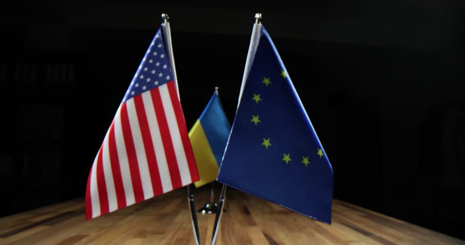National flags of Ukraine USA and European Union flag on table. Help Ukraine in war with Russia