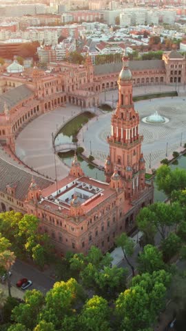 Flying over the Plaza de Espana at sunrise in Seville, Spain. Aerial view of the famous Spanish Square and Maria Luisa park in the morning in Seville, Andalusia region.
