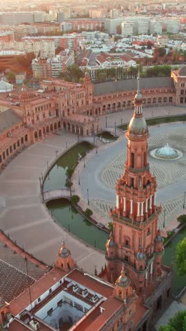 Flying over the Plaza de Espana at sunrise in Seville, Spain. Aerial view of the famous Spanish Square and Maria Luisa park in the morning in Seville, Andalusia region.