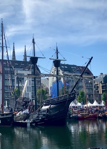 Beautiful short video, footage, vintage boat, ship, maritime in the harbor in Ostend, Belgium Europe and blue sky, sea, buildings, cathedral background 