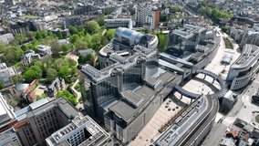 Aerial Drone View of European Parliament Building in Brussels, Capital of Belgium, EU. Aerial Panorama of Modern Glass Building as Politics Power Landmark. Brussels Skyline. 4K - Powered by Shutterstock - Get 15% off with code: PIKWIZARD15