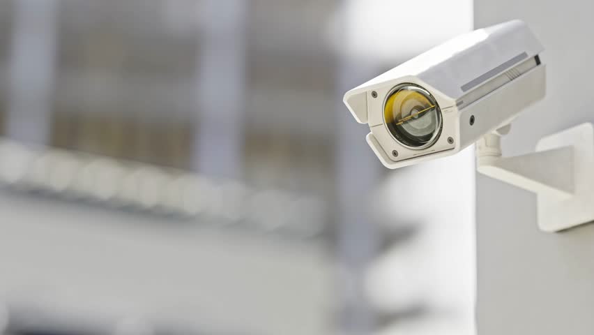 CCTV camera installed on wall of the building. Scan the area for surveillance purposes. Can be used background in security work. Animation, 3D Render.