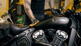 a motorbike base in the repair department master polishes all parts of a motorbike - Powered by Shutterstock - Get 15% off with code: PIKWIZARD15