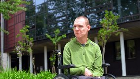 Close-up portrait of a proud man with cerebral palsy in the university campus looking up - Powered by Shutterstock - Get 15% off with code: PIKWIZARD15