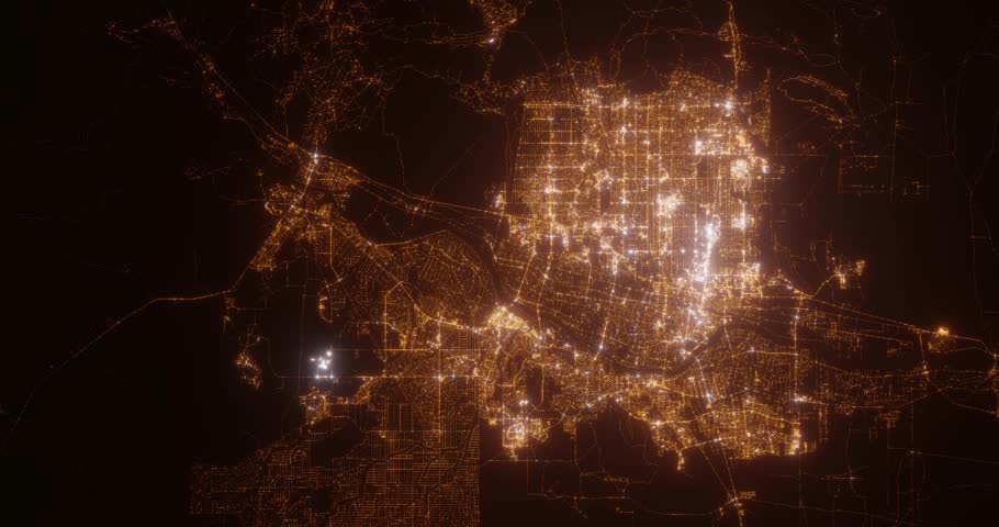 Albuquerque (New Mexico, USA) top view at night. Aerial view on modern city with lights. Camera is flying above the city, moving backward. Vertical video. The north is on the left side