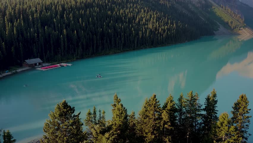 Lake Louise is located in the Rocky Mountains of the province of Alberta, Canada. Enveloped by lush forests and dominated by the Victoria Glacier. Excursions. Canoe. Crystal clear lake. Sunrise.