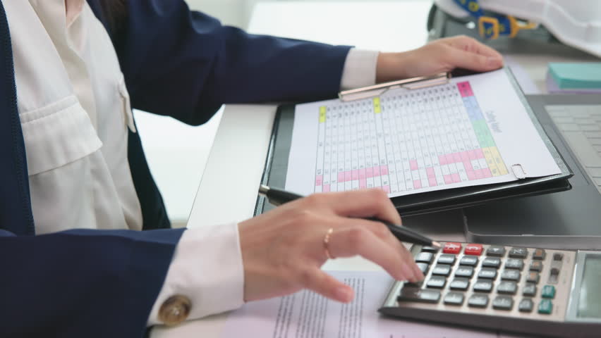 Expert woman asian female people review data number costing managerial account prepare monthly actual cost variance report at tax audit office. ESG sheet budget control ERP process service project.