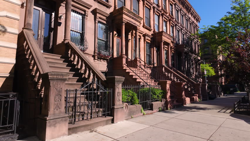 Harlem Brownstones with stoop steps in Harlem (Mount Morris Park Historic District). Row of Townhouses Manhattan in New York City