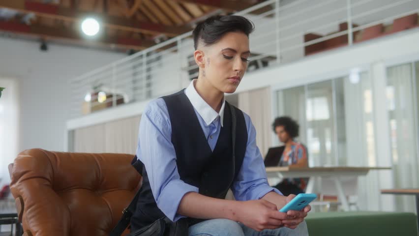Low angle of Thoughtful business woman sitting and waiting on sofa of business lounge.