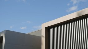 Designer elegant roof of building with clear sky in background. Combination of solid and striped patterns on facade with stripes providing interesting textural contrast - Powered by Shutterstock - Get 15% off with code: PIKWIZARD15